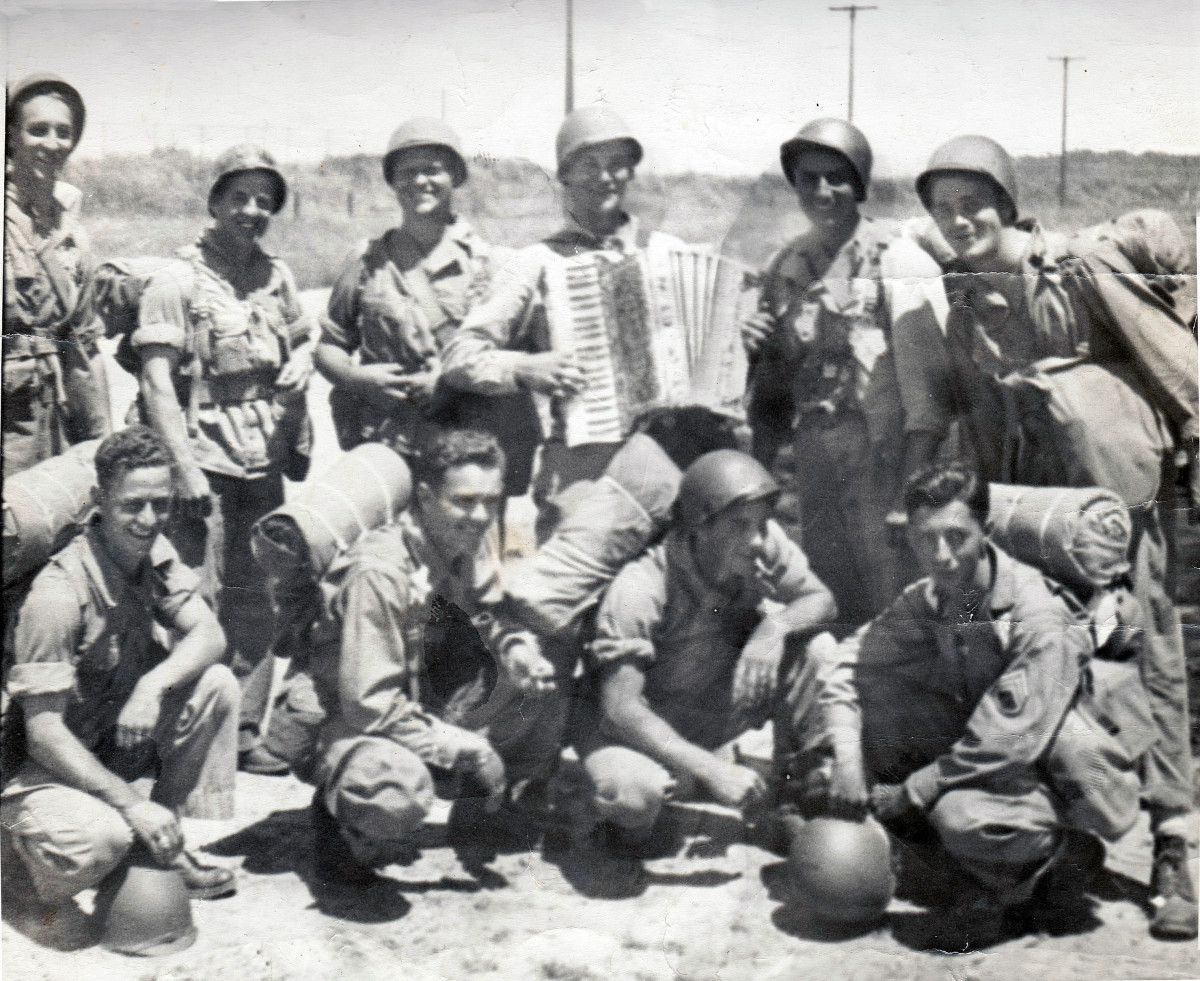 July 2,1943 during a 15 mile hike near Mt. Clemens, MI: L - R is  1. Bill Marske -  Ohio 2. Donald Blystom - Indiana 3. Edward A. Wiza - Penna 4. my dad, Pfc. Ralph A Mannisto - Michigan (with accordion) 5. Anthony Ferraro - Pueblo, Colorado 6. Pfc. Walter C. Stone Jr. - N. Car 7. ? 8. Pvt. Shannan Bargsis - W. VA 9. Pfc. Elmer Dale Surnney - Texas 10. S/Sgt B.D.Hendrix - N.C.